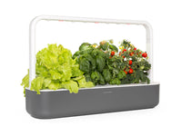 The Smart Garden 9 / A close up side view of The Smart Garden 9 by Click and Grow in a gray container.