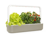 The Smart Garden 9 / A close up side view of The Smart Garden 9 by Click and Grow in a beige container.